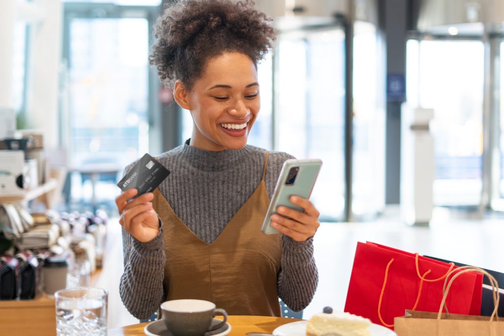 Young woman shopping for clothes online, representing buying and selling gift cards in Nigeria through Zabira for easy and secure transactions.